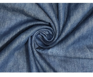 Close-up detail of medium blue denim fabric texture and soft drapery of the summer dress