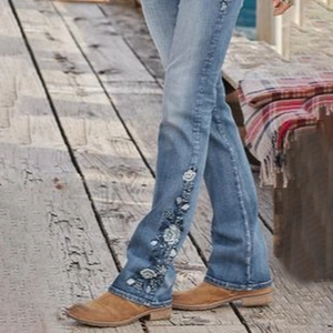 Women high waisted light blue flare jeans featuring vintage floral embroidery details