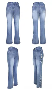 Detail view of high waist flared jeans featuring delicate white floral side embroidery