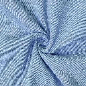 Light blue denim summer dress featuring premium twill weave fabric and soft texture detail