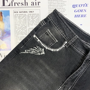 Slim fit dark gray denim jeans with embroidered wing patterns and rhinestone details