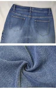 Detailed view of blue denim jeans rear pockets with vintage stitching and texture