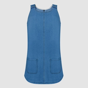 Detail view of denim sundress showing metal shoulder buckles and front pockets