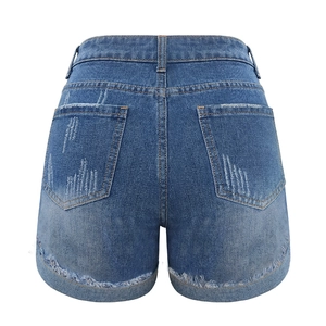 Rear view of high-waisted blue denim shorts with washed effect and distressed rolled hems