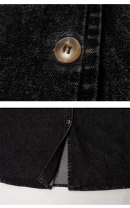 Detailed macro view of amber resin buttons and split hem on washed black denim dress