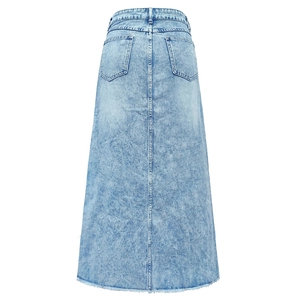 Detail of light blue washed denim maxi skirt featuring back pockets and frayed fringe hemline
