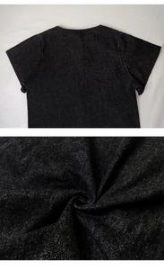 Detail of dark gray washed denim fabric with subtle metallic shimmer and texture