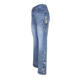 Vintage high waist flared jeans with delicate white floral embroidery in light blue denim