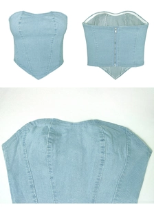 Dettaglio del bustier in denim con orlo a V e chiusura posteriore con zip in metallo argento