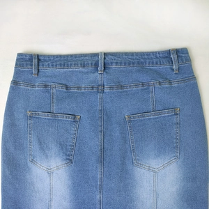Detail view of denim skirt back with twin pockets and washed blue texture