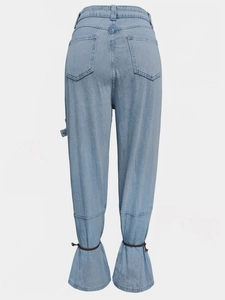Detail of light blue denim cargo pants showing back pockets and ruffled drawstring hems