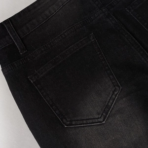 Detail view of the rear pocket and stitching on vintage black cargo denim jeans