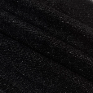 Close-up of durable black heavy denim fabric showing twill weave texture and detail