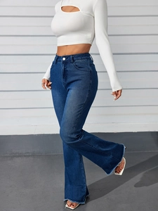 Detail shot of the frayed hem and vintage blue denim texture on high-waist flared jeans