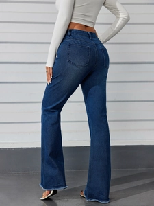 Detail view of high waisted dark blue flared jeans with raw hems and back pocket design