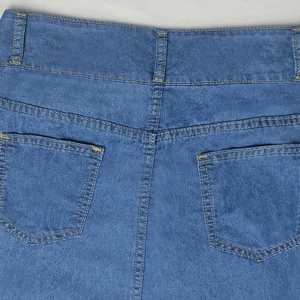 Detail of high waist denim skirt featuring back pockets and classic gold topstitching