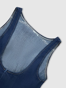 Detail of dark blue denim dress showing contrast yellow stitching and invisible zipper