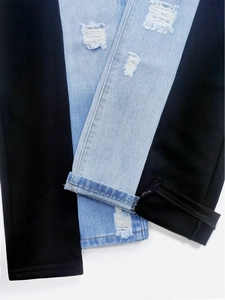 Slim fit high waist patchwork denim jeans with distressed ripped details and cuffed hems