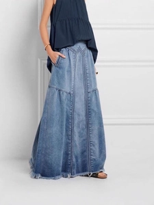 High-waisted washed blue denim A-line maxi skirt with decorative seams and raw hem details