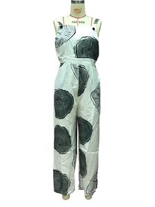 Detail of high-waisted white wide-leg jumpsuit with black concentric wood grain pattern