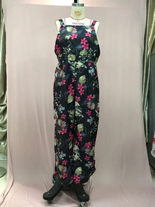 Detailed view of summer floral print jumpsuit with wide-leg cut and palm leaf patterns
