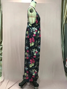 Side view of backless jumpsuit featuring pink floral print on black fabric for summer beach wear