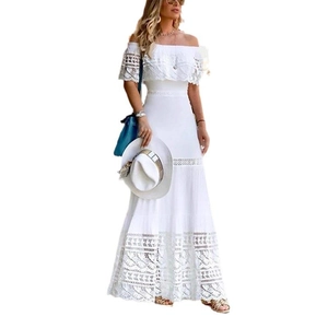 Detailed close-up of intricate lace embroidery and tiered skirt of white off-shoulder dress