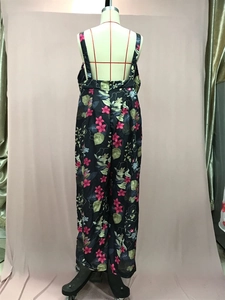 Rear view of floral wide-leg jumpsuit showing backless straps and draped fabric detail