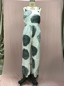 Detail view of white wide-leg jumpsuit with black concentric ring pattern and backless design