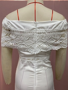 Detail of elegant white off-shoulder dress featuring exquisite lace back and invisible zipper