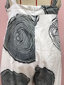 Close-up of back invisible zipper and wood grain print on summer wide-leg jumpsuit
