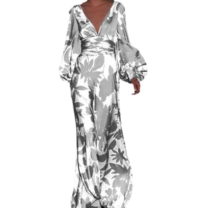 Detailed view of elegant floral print maxi dress featuring deep V-neck and puff sleeves