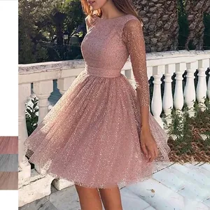 Detail of rose pink sequin cocktail dress with sheer mesh sleeves and sparkly finish