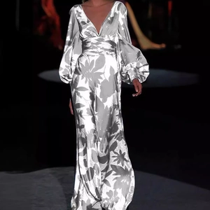 Elegant silver-grey floral maxi dress with deep V-neck and lantern sleeves on runway