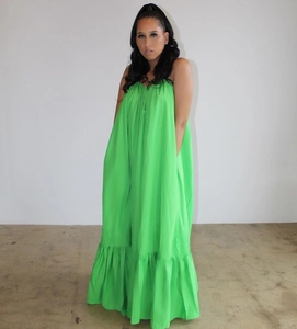 Detail view of bright green sleeveless tiered maxi dress with ruffled hem and loose A-line cut