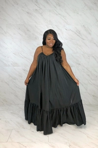 Detail of black summer dress featuring pleated chest and tiered ruffle hemline design