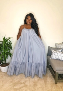 Detail of light grey oversized tiered maxi dress with thin straps and ruffled hem