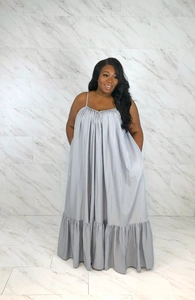 Detailed view of silver satin dress featuring a gathered neckline and thin spaghetti straps