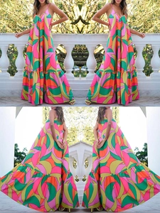 Detail of summer floral maxi dress featuring colorful abstract print and tiered ruffle hem