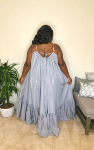 Rear view of a light blue maxi dress featuring thin straps and back lace-up detailing