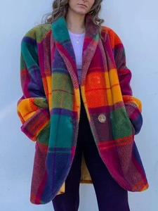 Detail of vibrant color-block plaid wool coat with large lapel and oversized silhouette