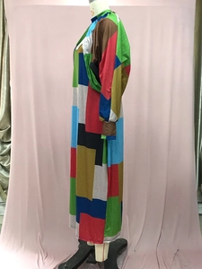 Detail view of maxi dress featuring colorful geometric patchwork and stand collar design