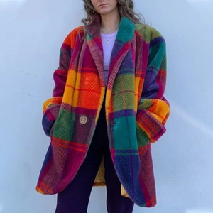Detail of oversized colorful plaid wool coat with notched lapels and single-breasted buttons