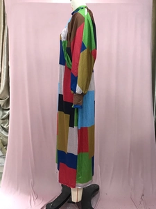 Detail of multi-color geometric patchwork print on long-sleeved knit dress with ribbed cuffs