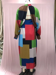 Detail view of the back teardrop cutout on a geometric color-block long sleeve dress