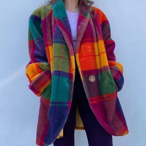Detail of colorful oversized plaid coat featuring vibrant purple orange green patterns
