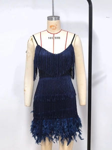 Detail of the dark blue sequin dress featuring tiered fringes and soft feather trim at the hem