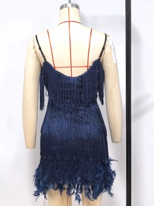 Detail of navy blue sequin party dress with fringe layers and feather hem on mannequin