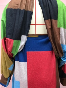 Detailed view of bohemian long sleeve dress featuring colorful geometric patchwork print