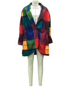 Macro view of plaid wool coat showing multi-color block pattern and button detail